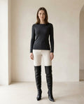Black over-the-knee boots on model, front view | Maison Perigee — front