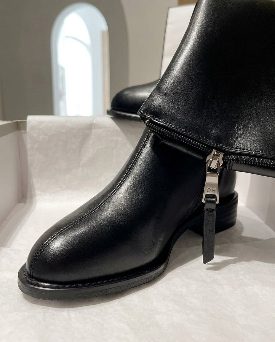 Black knee-high boots material and heel detail | Maison Perigee — detail