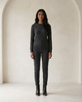 Black ankle boots on model, front view | Maison Perigee — front