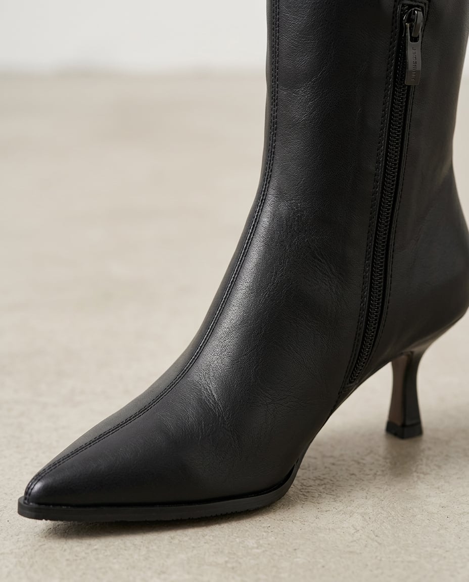 Black knee-high boots material and heel detail | Maison Perigee — detail